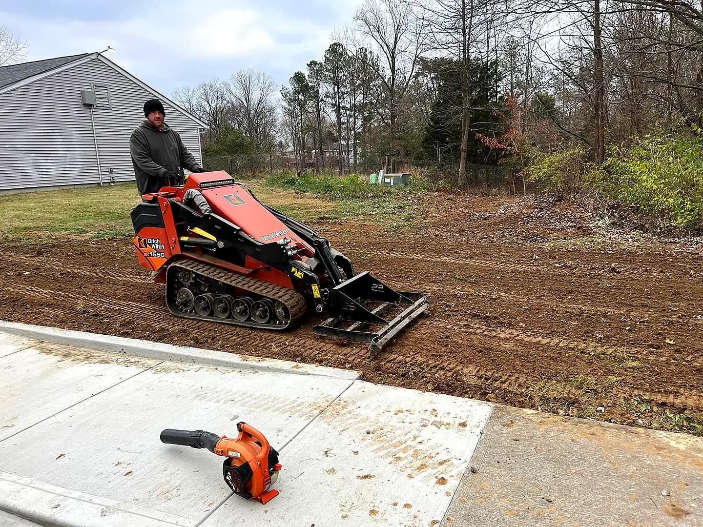 Kirks Mowing grading and landscaping a residential property in Southern Indiana